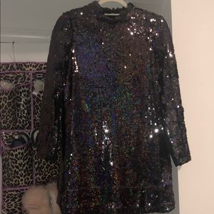 A knee length black holographic sequin dress